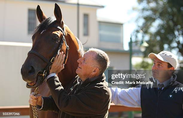 John singleton poses with Big Brown at a media conference announcing the arrival of world champion racehorse Big Brown at the Inglis Stables on...