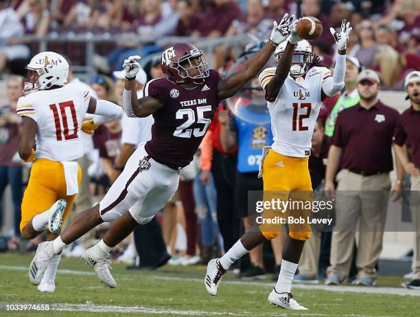 Tyrel Dodson of the Texas A&M Aggies knocks the ball away from Jarell Brown of the Louisiana Monroe Warhawks in the first half at Kyle Field on...