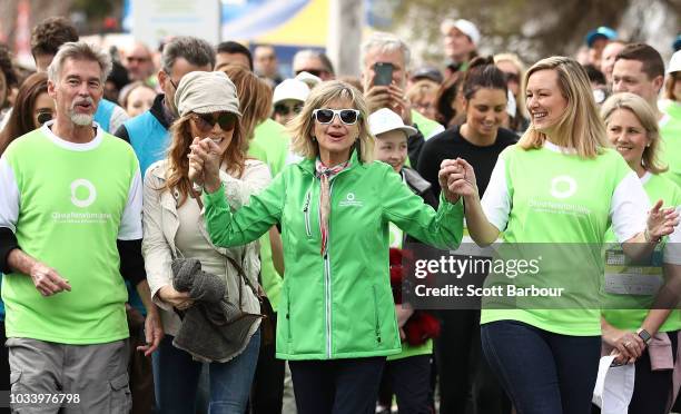 Olivia Newton-John and her husband John Easterling along with Tottie Goldsmith and Melissa Doyle hold hands as they begin the walk during the annual...