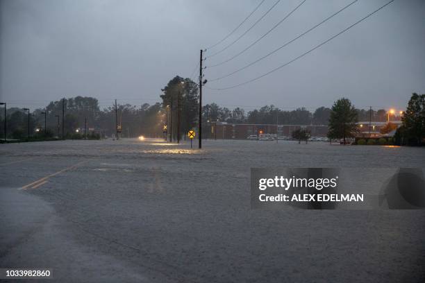 This photo shows a road submerged in floodwater in Lumberton, North Carolina, on September 15, 2018 in the wake of Hurricane Florence. - Besides...