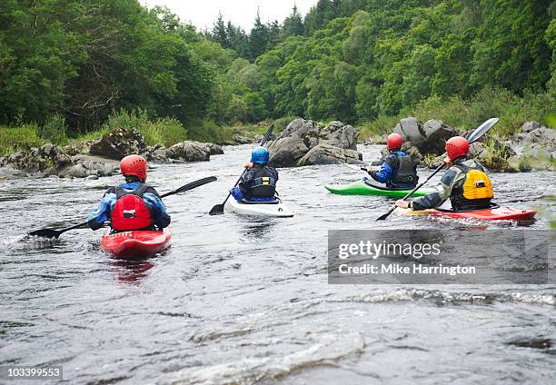 four people kayaking - kajak stock-fotos und bilder