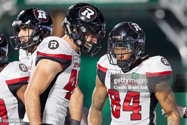 Harris and Jean-Christophe Beaulieu of the Ottawa Redblacks celebrate after a touchdown in the game between the Ottawa Redblacks and Saskatchewan...