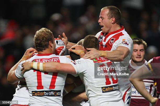 Michael Weyman of the Dragons is congratulated by his team mates after scoring try during the round 23 NRL match between the St George Illawarra...