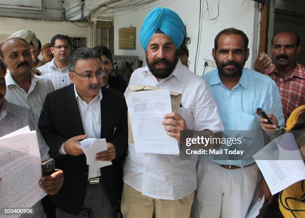 Leaders RP Singh and Ramesh Bidhuri along with their advocate after filing an FIR at a police station against IOA President Suresh Kalmadi alleging...