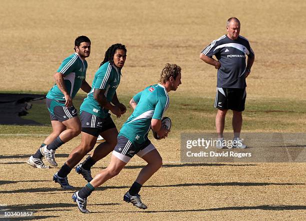 Graham Henry, the All Black head coach looks on as Jimmy Cowan runs with the ball with Ma'a Nonu and Piri Weepu in support during a New Zealand All...