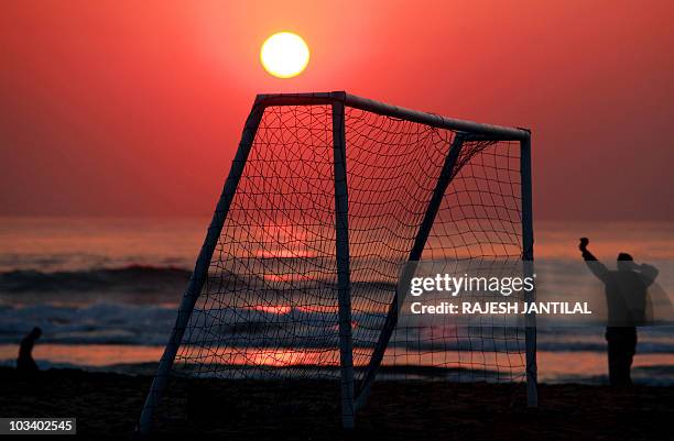 People visit the beach to catch the early morning sun at the North Pier Beach in Durban on June 25, 2010 before the 2010 World Cup Group G football...