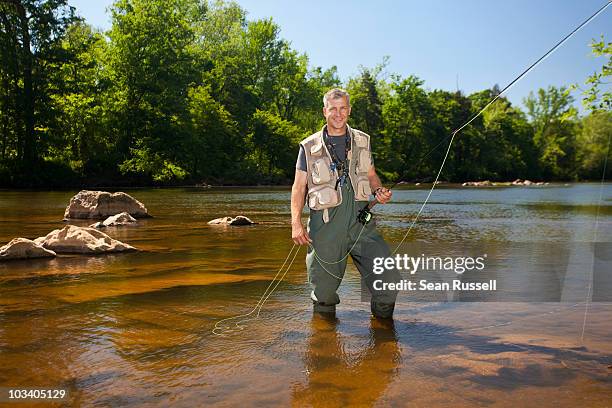 portrait of a man fly fishing in a river, north carolina, usa - fiskeväst bildbanksfoton och bilder