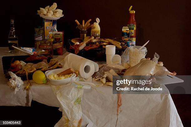 a table with a grill and an excess of various grilling meats and barbecue foods, still life - food stains stock-fotos und bilder