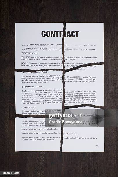 an employment contract torn into pieces - torn contract stock pictures, royalty-free photos & images