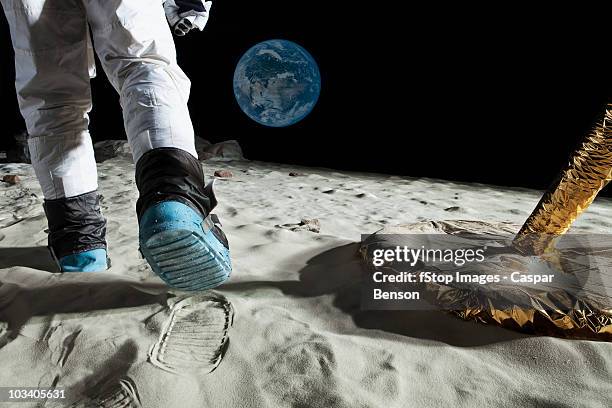an astronaut walking on the moon, rear view, low section - astronaut bildbanksfoton och bilder
