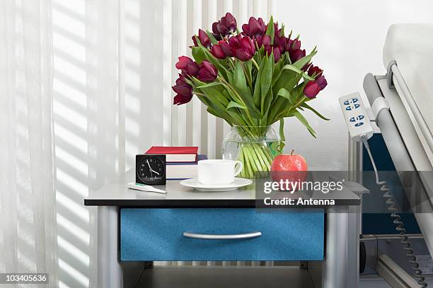 various objects on a bedside table in a hospital ward - bedside table stock pictures, royalty-free photos & images