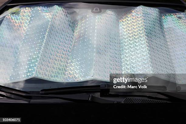 detail of a car windshield being protected from the sun - car sunshade stock pictures, royalty-free photos & images