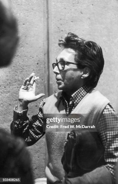 At an unspecified event, French author and filmmaker Marguerite Duras talks with an unseen companion, a cigarette in one hand and her purse in the...