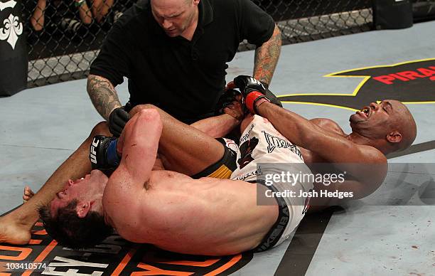 Referee Josh Rosenthal stops the fight between Chael Sonnen and Anderson Silva during the UFC Middleweight Championship bout at Oracle Arena on...