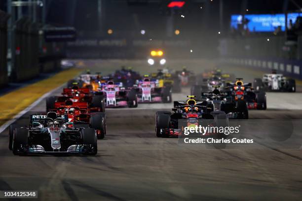 Lewis Hamilton of Great Britain driving the Mercedes AMG Petronas F1 Team Mercedes WO9 leads Max Verstappen of the Netherlands driving the Aston...