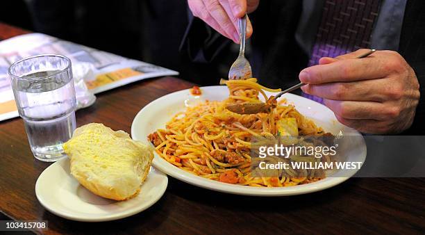Diner twirls his spaghetti at Pellegrini's Expresso Bar in Melbourne, on April 14, 2010. Opened in 1954, Pellegrini's is a Melbourne favourite with...