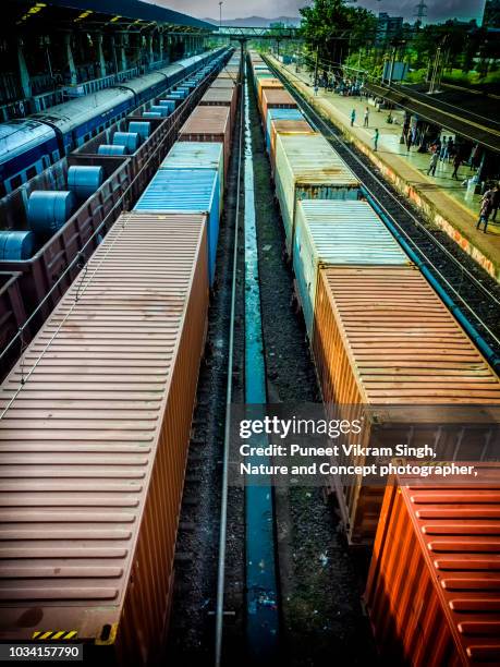 goods train of indian railways carrying steel products and rolls - train de marchandises photos et images de collection