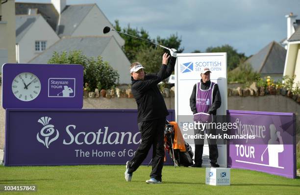 Andrew Oldcorn of Scotland plays his tee shot to the 1st hole during Day Three of the Scottish Senior Open at Craigielaw Golf Club on September 16,...