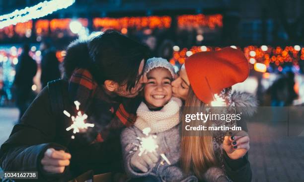 happy family on christmas with burning sparklers - christmas gala stock pictures, royalty-free photos & images