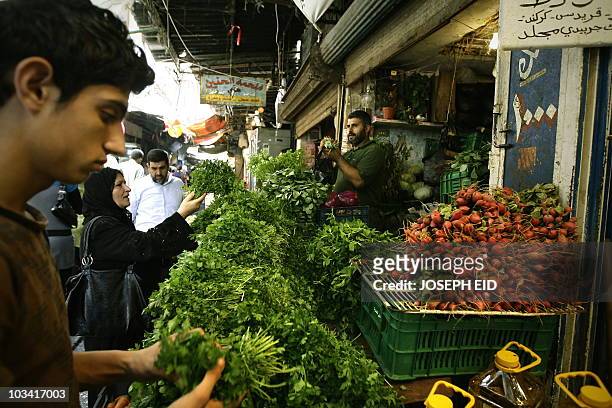 Lebanese shop for vegetable ahead of the Iftar or breaking of the daylong fast in old market in the ancient coastal city of Tripoli, north of Beirut,...