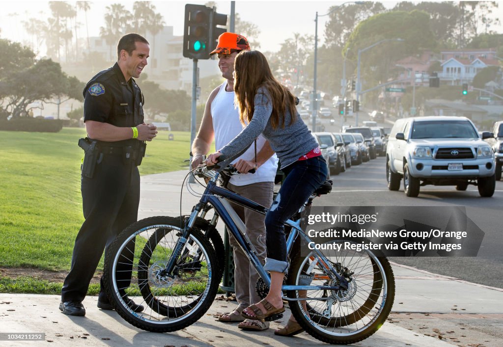 Jeff Calvert Lt. Jeff Calvert, left, of the Laguna Beach Police Department, chats ...