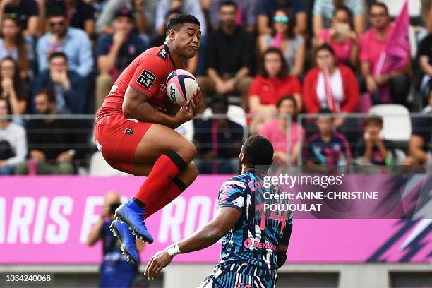 Toulon's wing Julian Savea vies with Stade Francais Paris' Fidjian winger Waisea Nayacalevu Vuidravuwalu during the French Top 14 rugby union match...