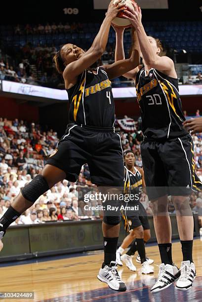 Amber Holt and Nicole Ohlde both of the Tulsa Shock grab a rebound against the Connecticut Sun during the game on August 17, 2010 at Mohegan Sun...