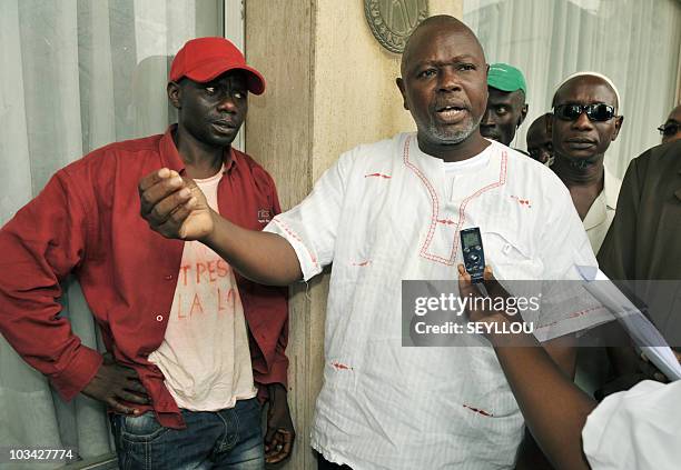 Alioune Tine , member of African NGO for the Defense of Human Rights , speaks to the media next to Senegalese artist Souleymane Diouf aka Farah on...