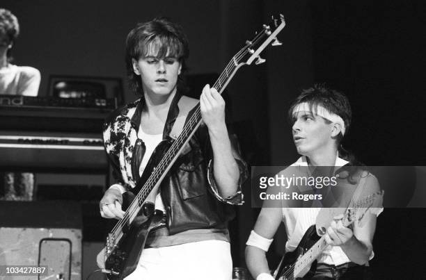 Bassist John Taylor and guitarist Andy Taylor of Duran Duran perform on stage at Wembley Arena in London, England on December 19, 1983.