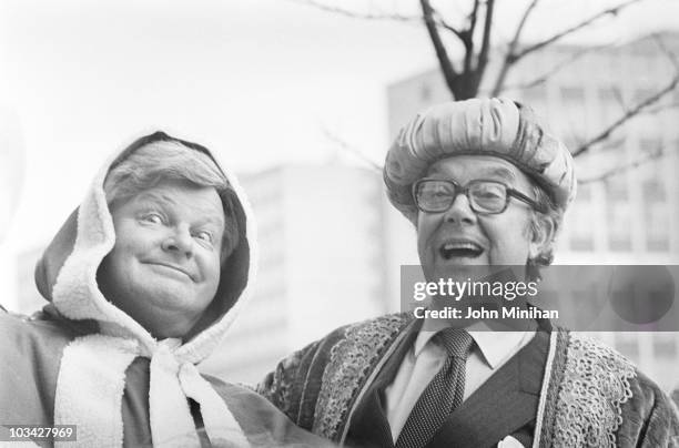 British comedians Benny Hill and Eric Morecambe promote their Thames Television Christmas specials in London, England in December 1983.