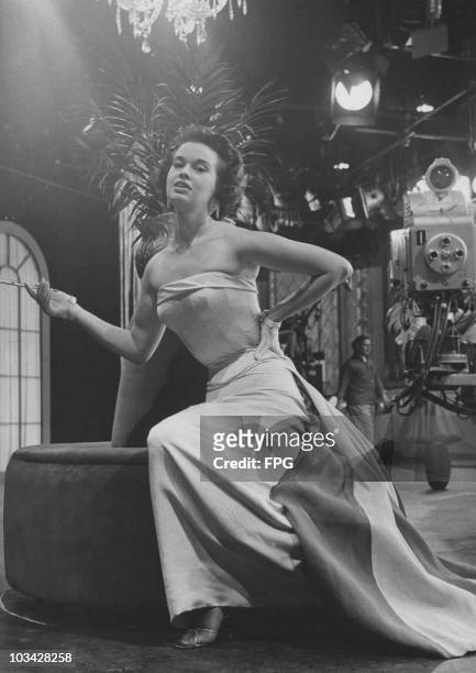 Socialite, actress and fashion designer Gloria Vanderbilt on a television set circa 1958.