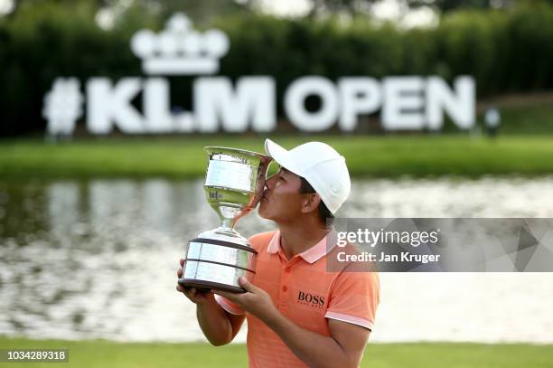 Ashun Wu of China poses with the trophy following victory in the KML Open during Day Four of the KLM Open at The Dutch on September 16, 2018 in...