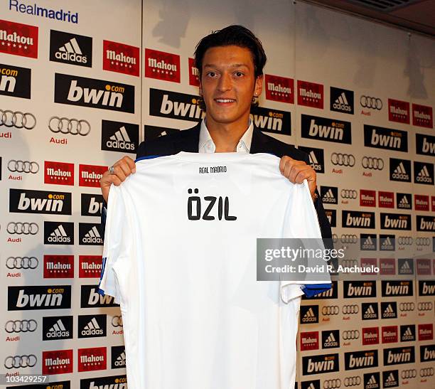 Mesut Ozil poses during a press conference during his official presentation at Santiago Bernabeu Stadium on August 18, 2010 in Madrid, Spain.