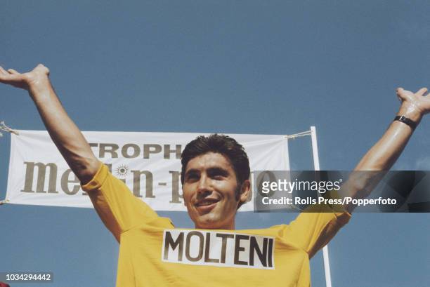 Belgian racing cyclist Eddy Merckx, wearing the Molteni team jersey, raises his arms in the air after the Molteni won the team time trial stage of...