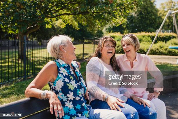 drei alte frauen lachen im park - retreat women diverse stock-fotos und bilder