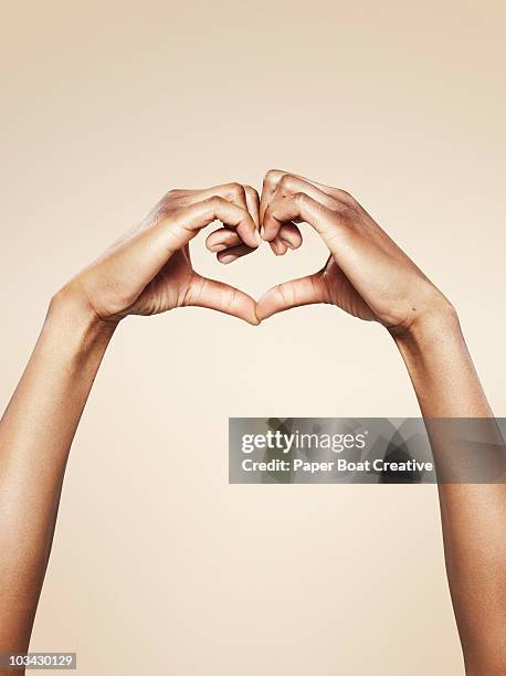 hands forming a cute heart shape - valentines african american 個照片及圖片檔