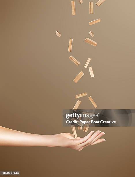 hand catching a bunch of falling wooden blocks - juggling stock pictures, royalty-free photos & images