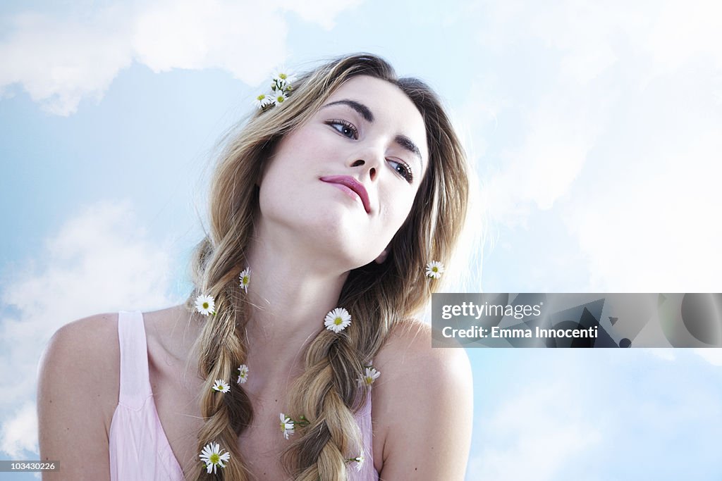Young woman with daisy in her hair