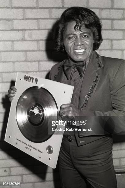James Brown performs on stage at Ahoy with a gold disc for the album Rocky IV on 20th April 1986 in Rotterdam, Netherlands.