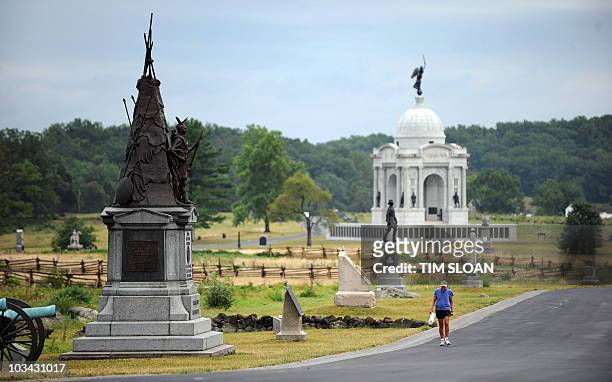 An early morning jogger on Cemetery Ridge passes by some of the 1200 memorials which dot this National Park on August 13, 2010 at the Gettysburg...