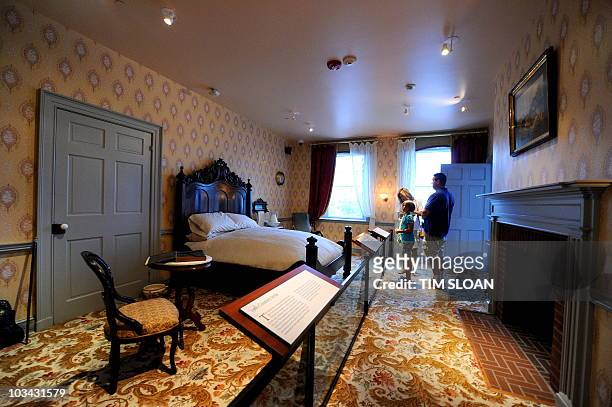 Tourists stand in the bedroom where former US President Abraham Lincoln revised his most famous speech and slept the night before the national...
