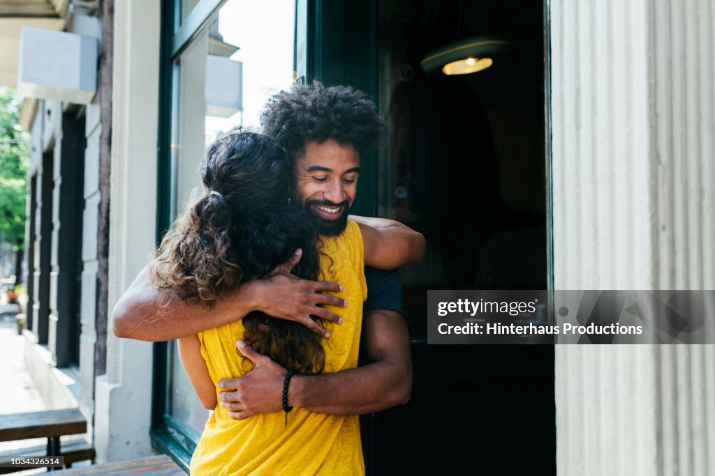 Friends Greeting Each Other Outside Restaurant