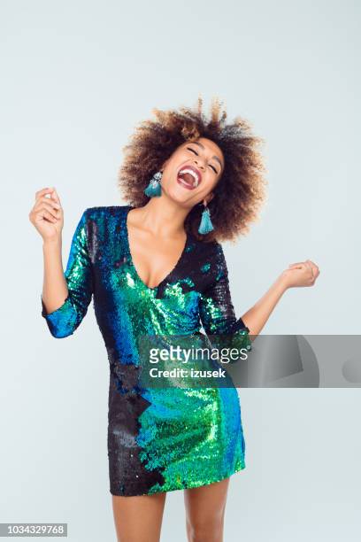beautiful afro american young dancing in sequined dress - green dress stock pictures, royalty-free photos & images