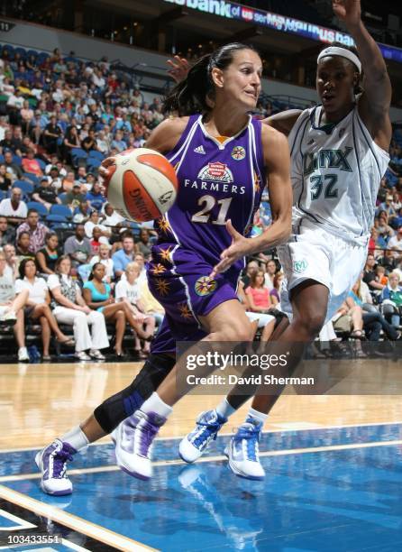 Ticha Penicheiro of the Los Angeles Sparks drives to the basket against Rebekkah Brunson of the Minnesota Lynx during a WNBA game on August 12, 2010...