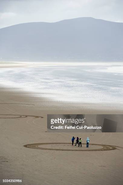 four people enjoying at beach at inch, kerry county, ireland - inch stock pictures, royalty-free photos & images