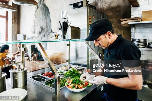 chef preparing salad dish for customer - cafeteria stock pictures, royalty-free photos & images