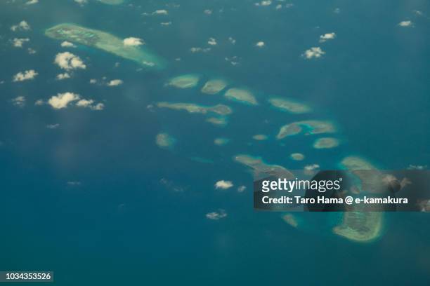 sabina shoal in spratly island in south china sea daytime aerial view from airplane - conflict islands stock pictures, royalty-free photos & images