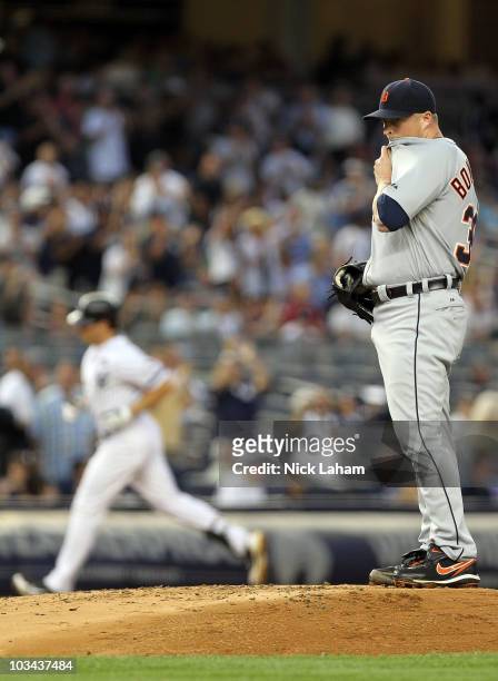 Jeremy Bonderman of the Detroit Tigers wipes his face as Mark Teixeira of the New York Yankees rounds the bases at Yankee Stadium on August 18, 2010...