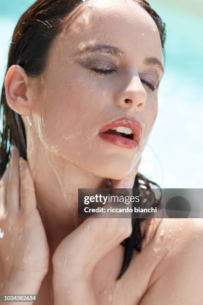 wet brunette woman with make up having a shower in sunlight - woman make up face wipes not men stock pictures, royalty-free photos & images