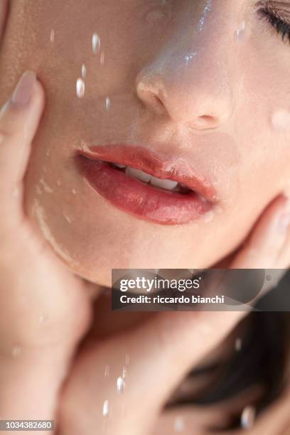 wet brunette woman with make up having a shower in sunlight lips detail - woman make up face wipes not men stock pictures, royalty-free photos & images